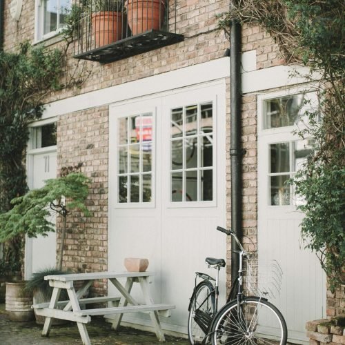 Black Bicycle Parked Beside White Wooden Chair